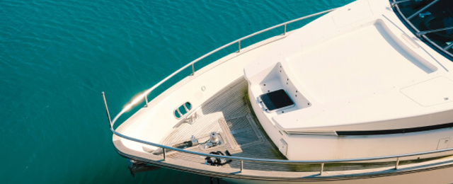 Nose of yacht on vivid blue green sea