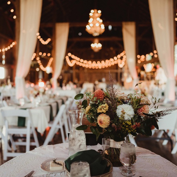 Spray of pink and white flowers on wedding table 