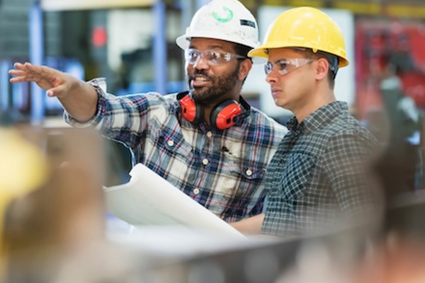 Workers taking instructions at building site