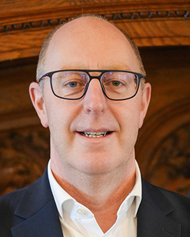 Adrian Scott - man with glasses looking at camera