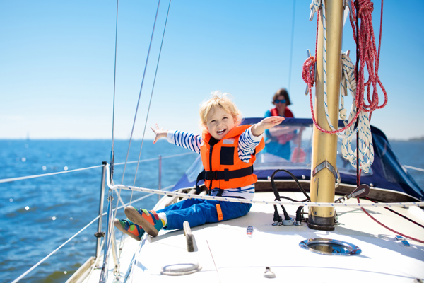 Smiling young boy in a sailing boat