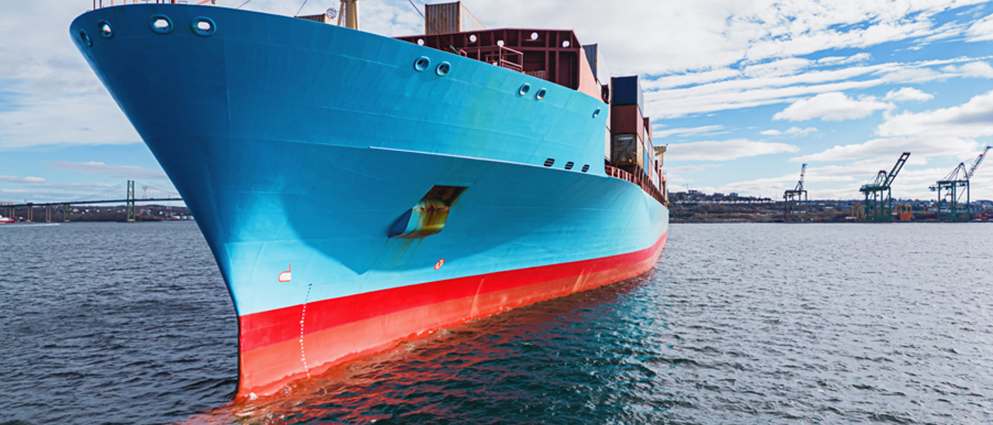 Blue Hull Of Large Cargo Ship At Sea