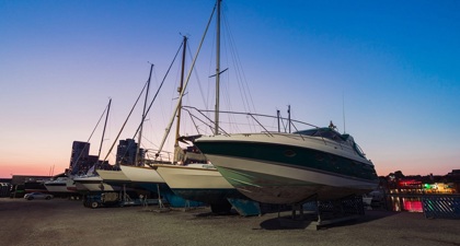 Yachts on dry land at sunset