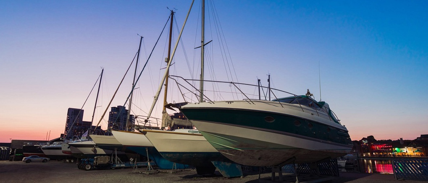 Yachts on dry land at sunset