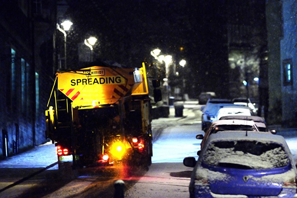 Gritter Truck Spreading Salt On A Road At Night In The Snow